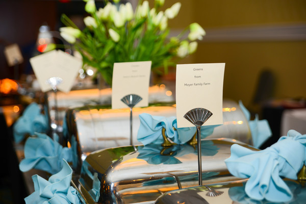 Elegant table setting with name cards and blue napkins.