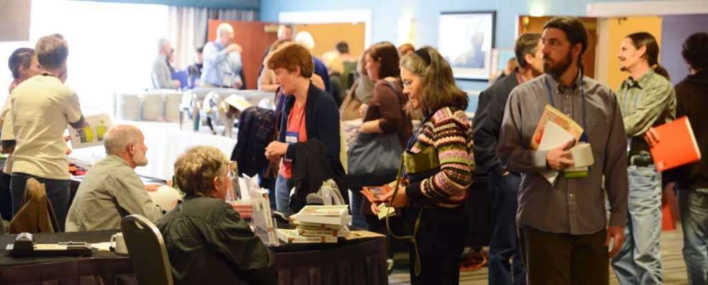 People shopping and interacting at an indoor market or event.