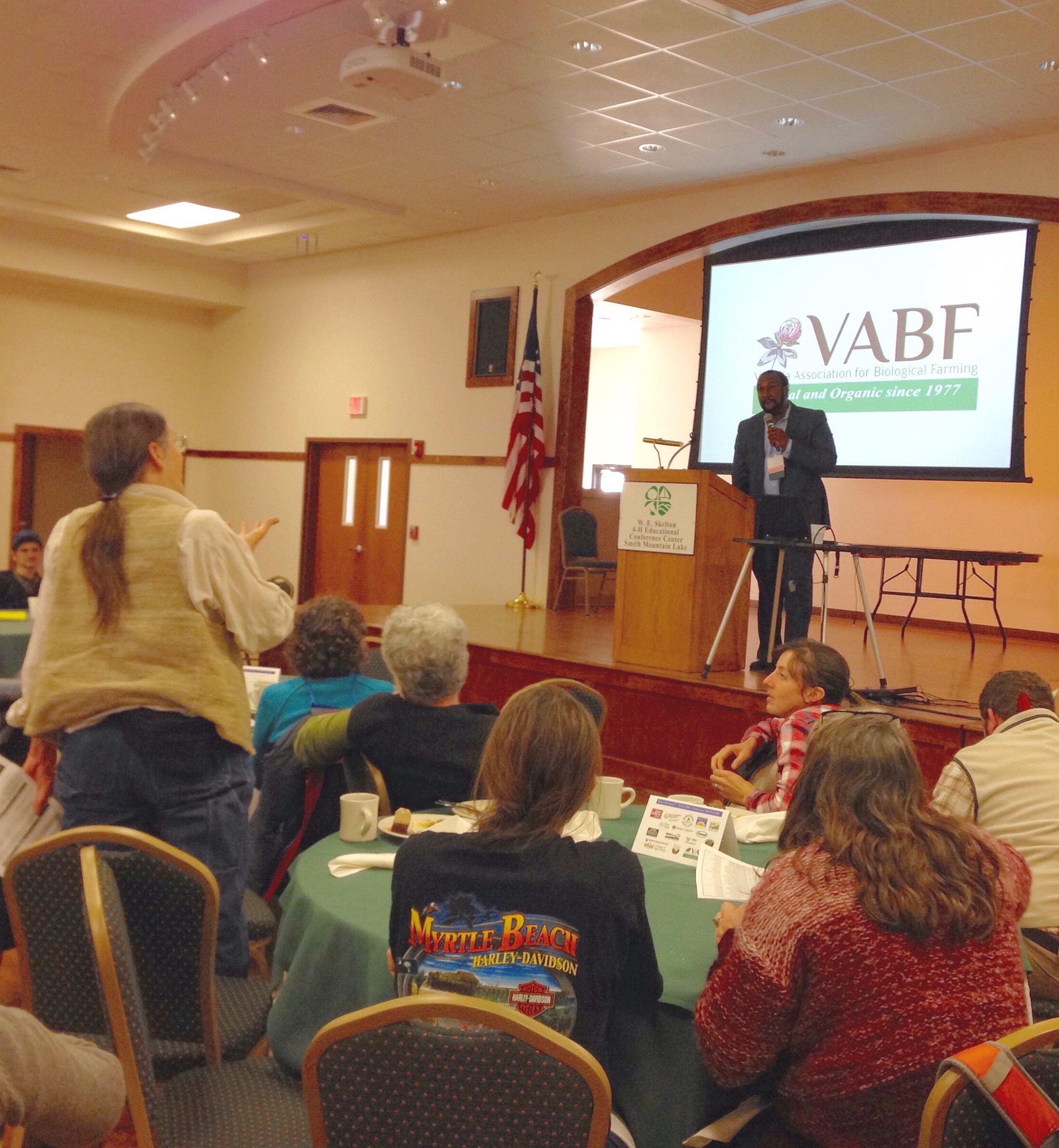 A speaker presents at a VABF meeting with an audience.