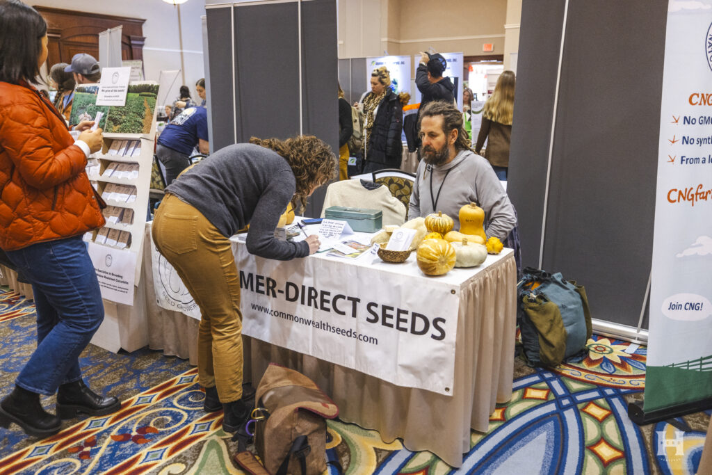 A vendor selling seeds at a market table.