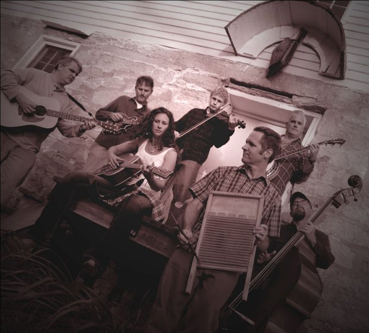 A sunflower held by two outlined hands inside a circular frame.